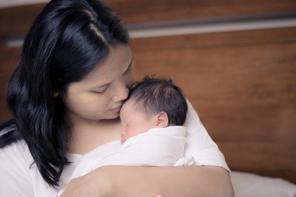 Мама Азия. Молодая азиатская мама держит ребенка. Mom and Newborn.